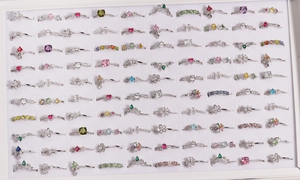 Detailed macro view of mixed fashion ring sets featuring floral, heart and crown designs