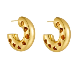 Detail of gold hollow heart pattern on thick C-shaped titanium steel hoop earrings