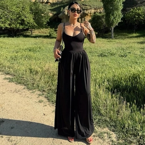 Chic black backless jumpsuit with spaghetti straps and wide leg for a summer street look