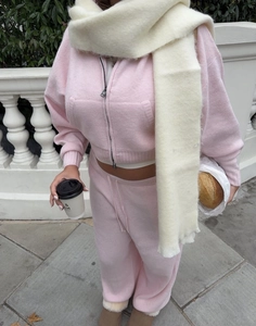 Pink knitted hooded tracksuit and cream fringe scarf shown in a stylish outdoor setting