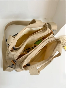 Beige multi-compartment nylon shoulder bag with three zipper pockets and large capacity