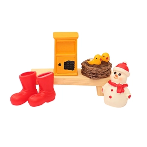 Miniature Christmas decor set with snowman and bird nest on wooden bench