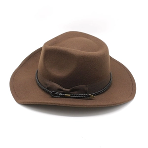 Close-up of brown wool felt cowboy hat with black braided band and gold metal buckle