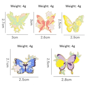 Set of five colorful floral butterfly enamel pins in various vibrant colors and sizes