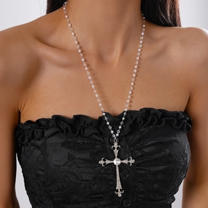 Detail of silver cross pendant with crystals and faux pearl glass beads necklace