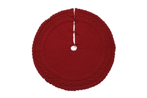 Detail of dark red knitted Christmas tree skirt featuring cable knit patterns and ties