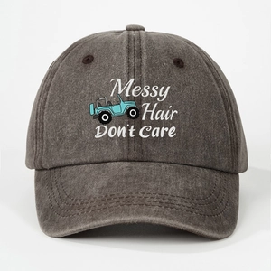 Detail of grey washed cotton baseball cap with Messy Hair Don't Care text and blue jeep icon