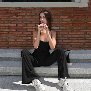 Close-up of black slim fit sleeveless jumpsuit featuring chic flared hem design details