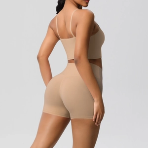 Rear view of nude yoga set featuring thin strap sports bra and high waist biker shorts