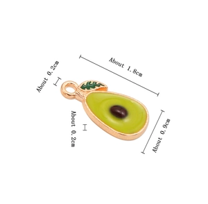 Macro view of small enamel avocado charm with specific dimension markings in cm