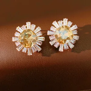 Elegant sunburst stud earrings with champagne cushion-cut crystal in gold finish