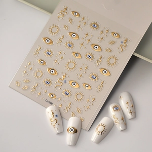 5D embossed nail stickers featuring golden stars, celestial sun, and evil eye designs