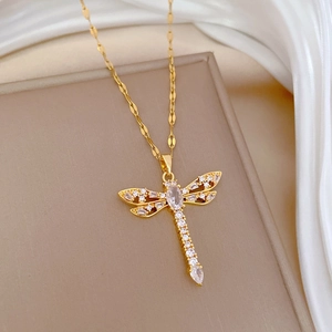Detailed view of a gold dragonfly pendant necklace with sparkling zircon stone accents