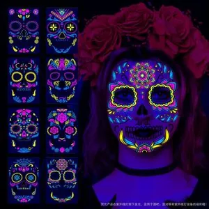 Neon Halloween skull face tattoo showing glow effect under UV light on dark background