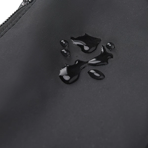 Detailed view of water-resistant black fabric with crystal clear droplets on surface