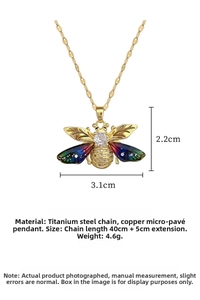 Detail view of colorful bee pendant necklace with zircon and gold titanium steel chain