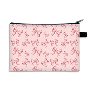 Pink bow makeup bag with white polka dots and black zipper for cosmetic storage