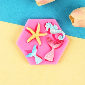 Pink silicone mold featuring starfish, seahorse, and mermaid tail shapes for cake decorating