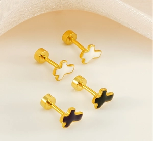 Detail of cross stud earrings with black and white enamel finish and secure screw backs