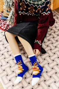 Detailed view of warm blue Christmas reindeer socks with soft white fuzzy plush trim