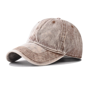 Detail shot of vintage washed brown denim baseball cap with premium texture and stitching