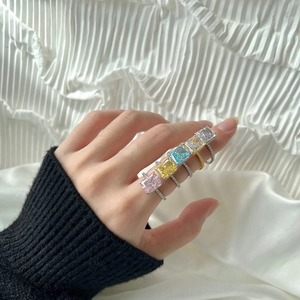 Close-up of five luxury S925 silver rings featuring multi-color rectangular ice-cut zircons