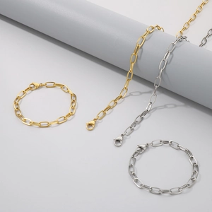 Close-up of hip-hop style stainless steel square link necklaces and bracelets in gold and silver