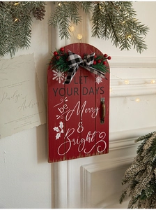 Close-up of rustic Christmas door sign with pine needles and Let Your Days Be Merry text
