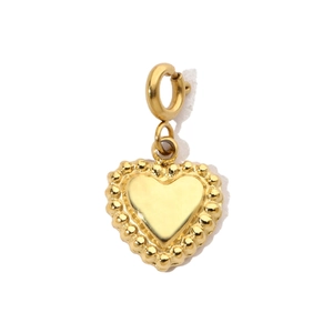 Macro detail of golden heart pendant with delicate beaded edge and polished finish