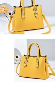 Detail of yellow leather tote bag with silver chain and adjustable shoulder strap