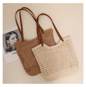 Detail of woven cotton shoulder bags with leather handles and metallic rivets