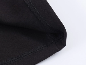 Detailed macro view of black fabric texture and high-quality stitching on polo shirt