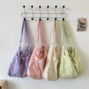 Dettagli delle borse con coulisse in seersucker ricamato in quattro colori pastello