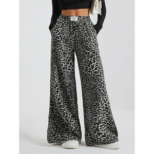 Detail of grey leopard print wide leg pants featuring an elastic waist and fluid fabric