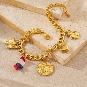Detailed view of a gold chain bracelet featuring colorful stone beads and butterfly charms