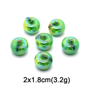Detail view of green glass apple pendants measuring 2x1.8cm for DIY jewelry making
