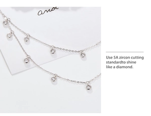 Close-up of 925 silver double-layered necklace with 5A cubic zirconia bezel set pendants