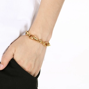Close-up of minimalist 18K gold plated stainless steel paperclip link chain bracelet on wrist