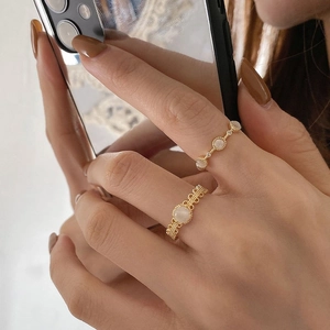Retro gold rings with opal stones in vintage hollow and chain style on finger