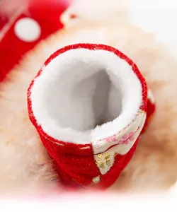 Detail showing plush inner lining and floral embroidery on festive pet winter clothing