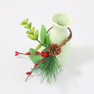 Christmas napkin ring with red berries, pine cones and green needles on a ceramic base