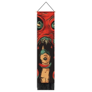 Close-up of bohemian wall hanging scroll with red monster and female character illustration