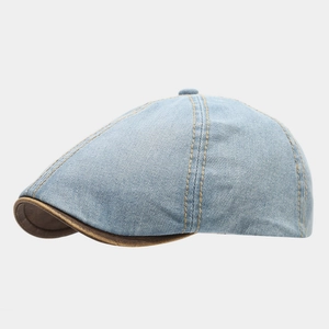 Classic light blue washed denim flat cap with contrast stitching and brown leather brim