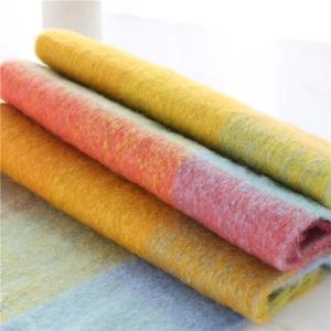 Detailed view of the soft brushed texture and vibrant rainbow plaid pattern of the scarf