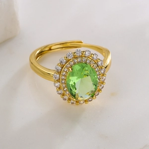 Detail of 18K gold-plated adjustable ring with green oval zircon and white diamonds