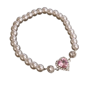 Elastic pearl bracelet featuring a pink heart-shaped zircon pendant on white background