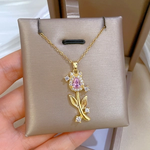 Elegant gold tulip necklace with a pink teardrop gem and sparkling micro-inlaid diamonds