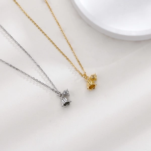 Detailed view of lily of the valley flower pendants in gold and silver finishes