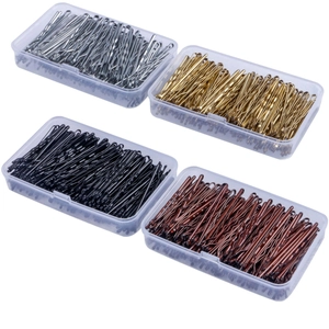 Macro shot of assorted metal hairpins in black gold silver and brown in clear cases