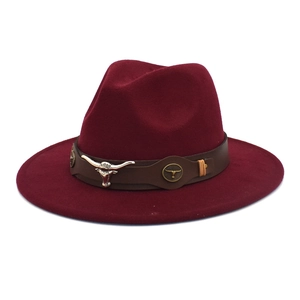 Detail of burgundy wool fedora with brown leather band and metal bull head ornament